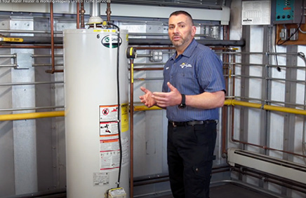 Petro service tech in front of water heater