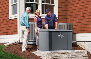 Petro technician next to a generator talking to happy couple