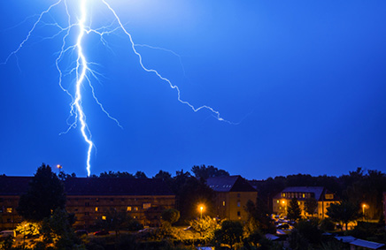 Image of lightning over homes